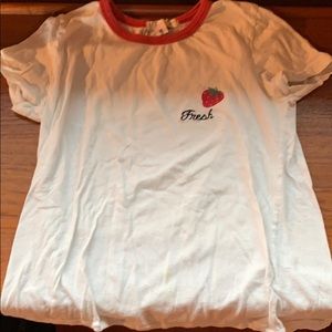 off white cropped shirt with a red neckline.